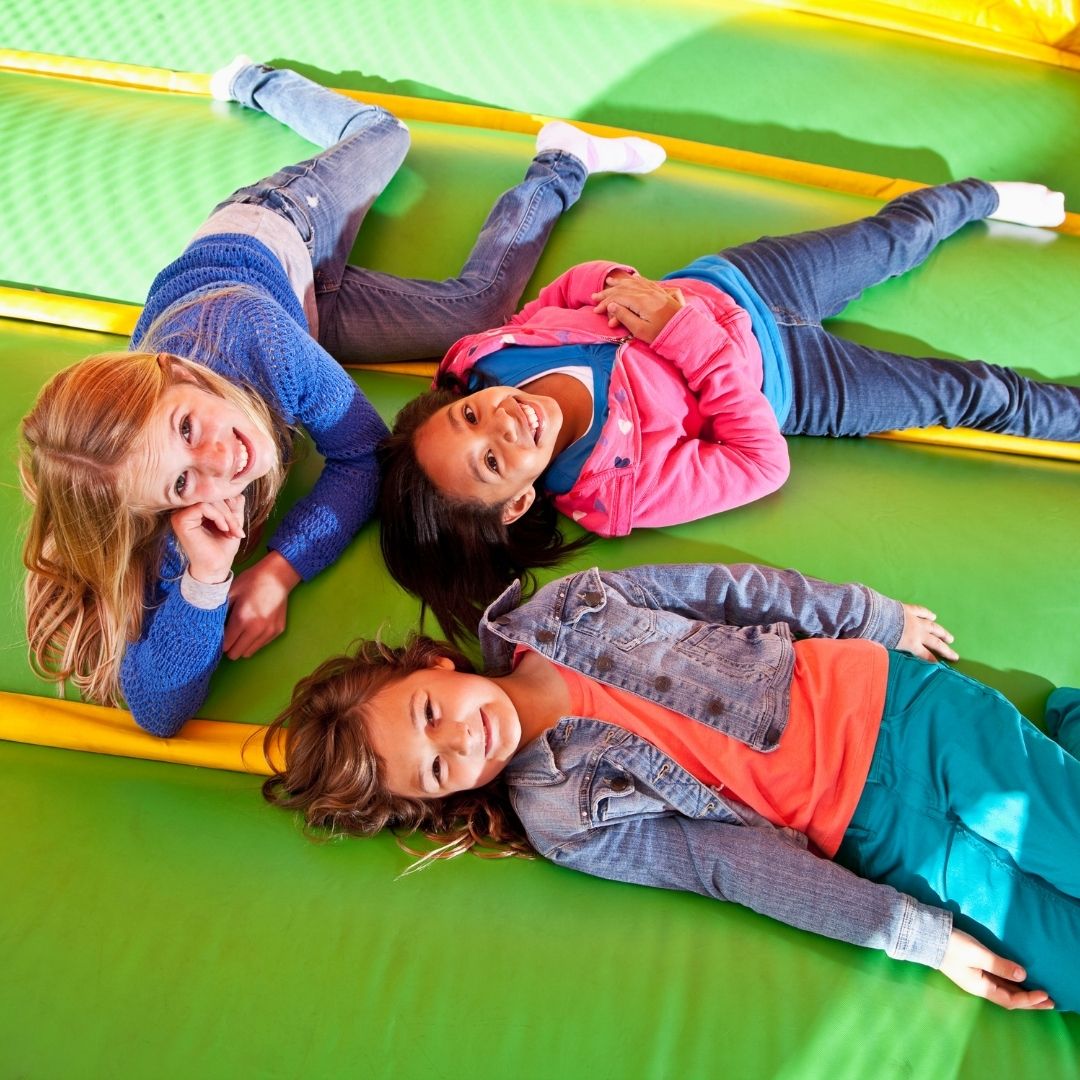 children playing in an indoor bounce house