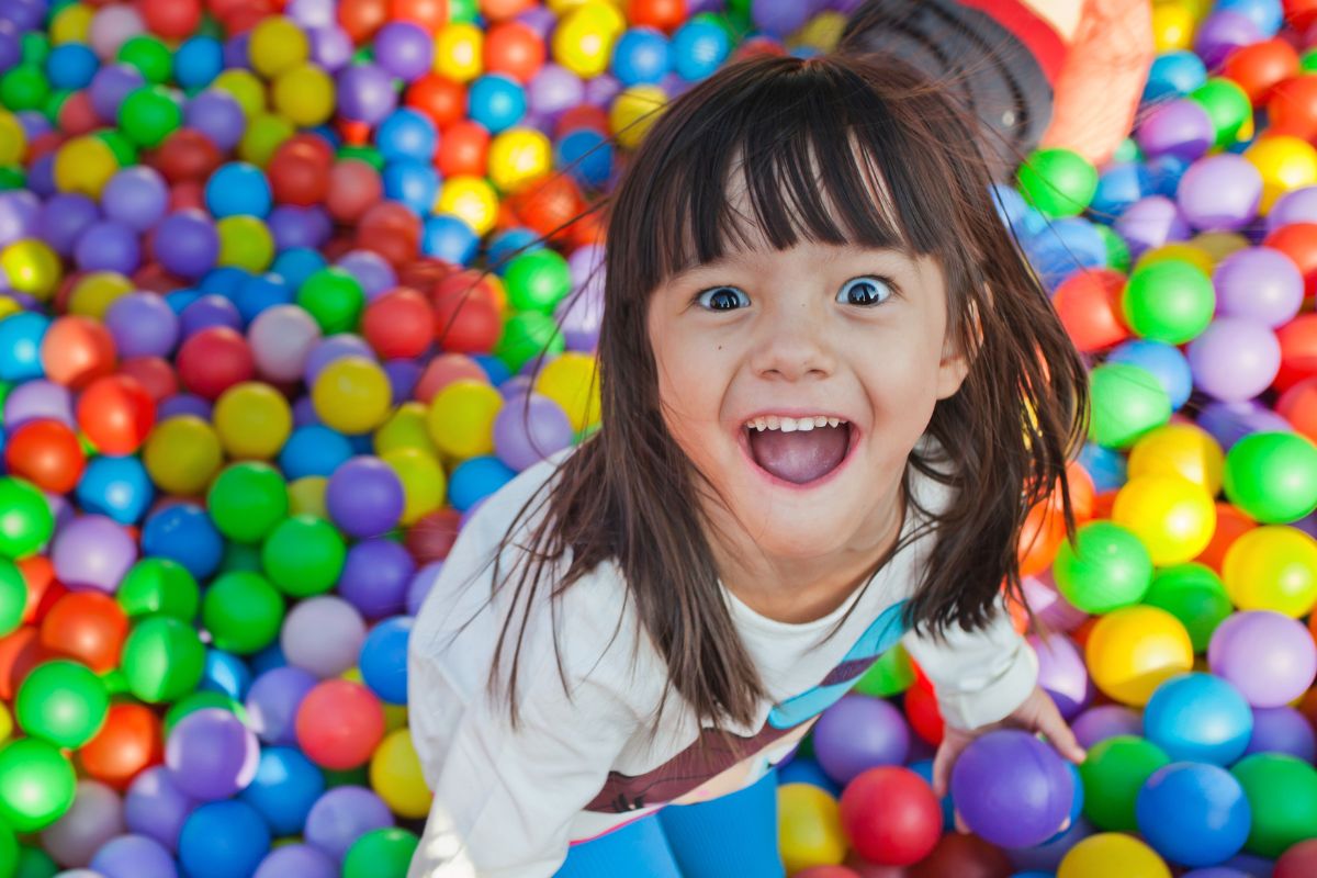 child playing in ball pit