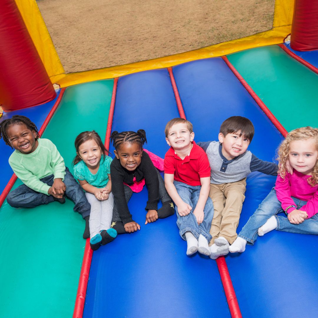 Group of kids sitting in bounce house