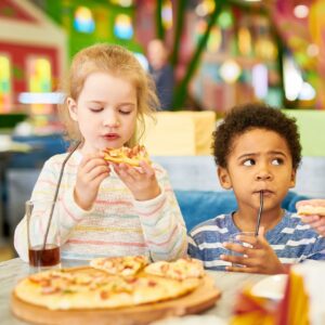 children enjoying pizza and drinks