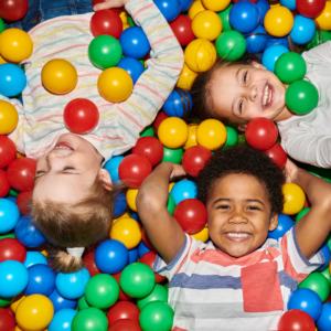 happy kids in a ball pit