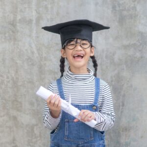 img of a child wearing a graduation cap