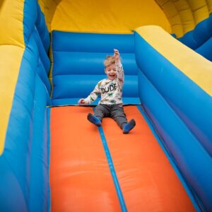 img of a kid on a bouncy slide