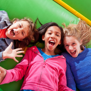 kids smiling in bounce house