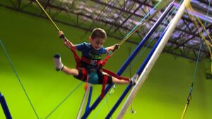 child bouncing in indoor bounce house