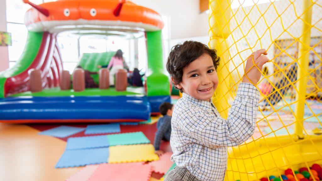 Toddler plays at a bounce house