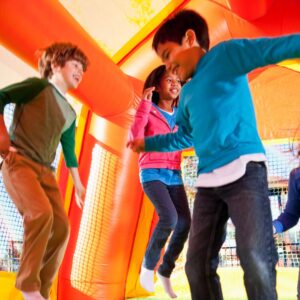 indoor bounce house and kids jumping 