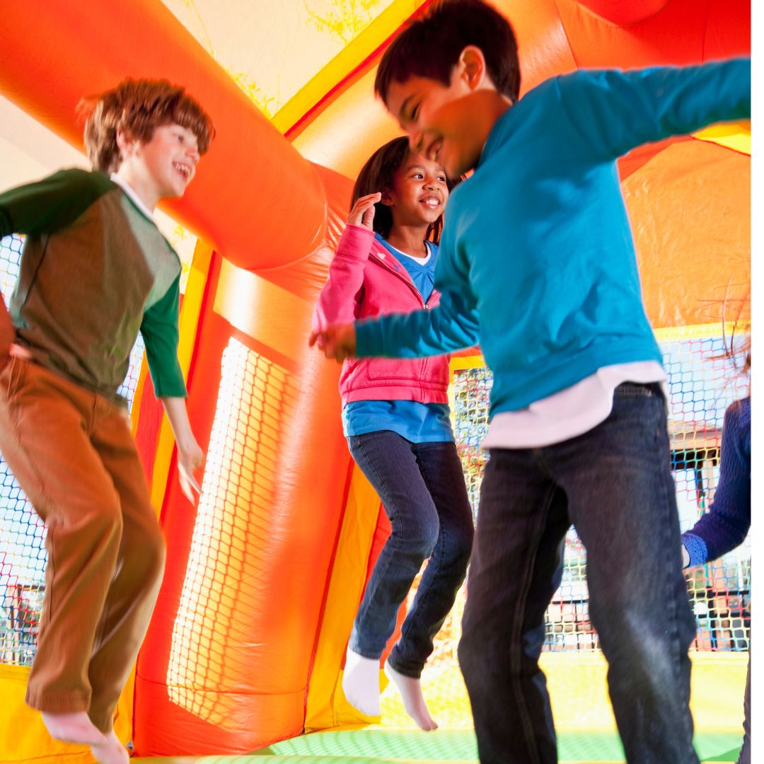 kids jumping in bounce house