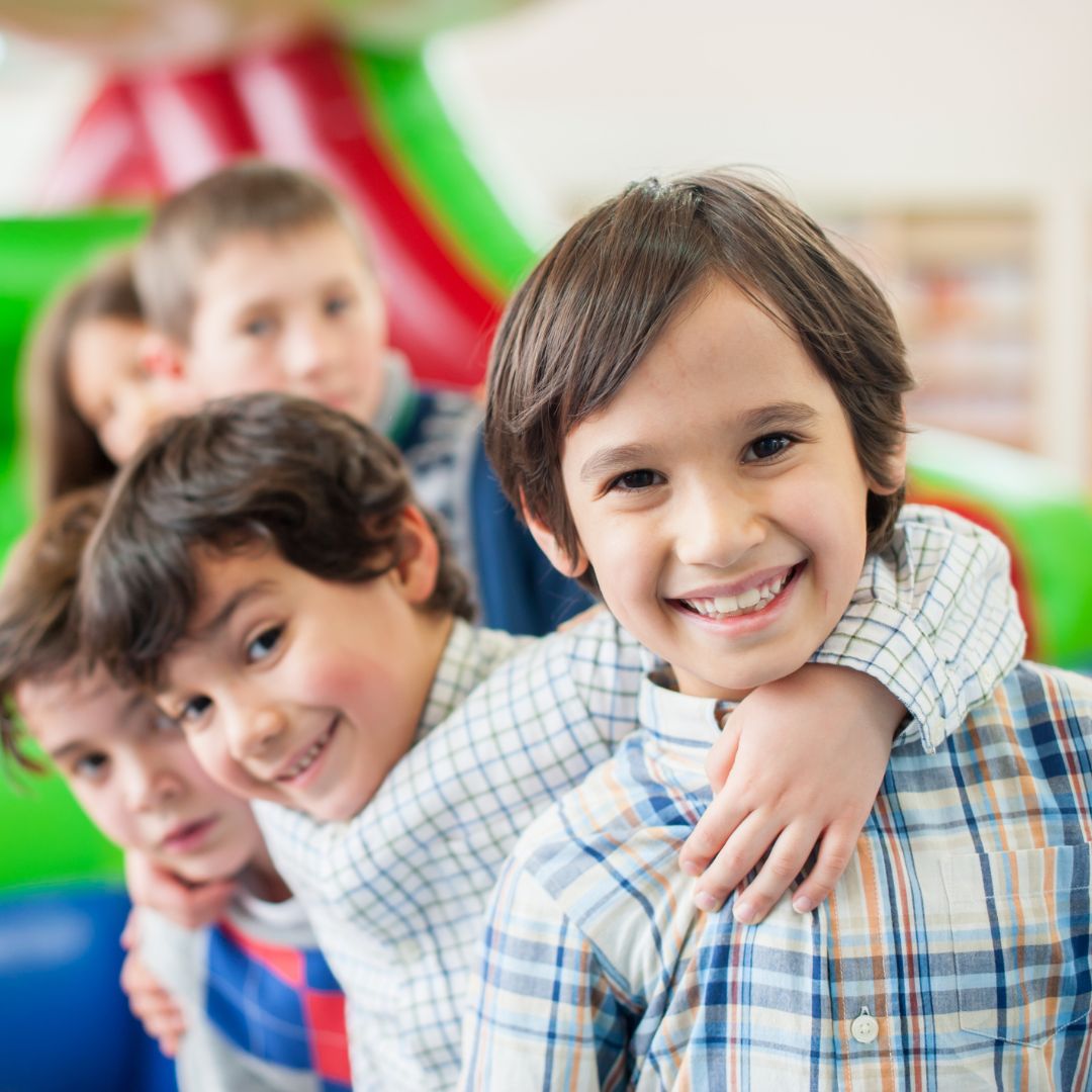 A smiling boy and his friends at a birthday party