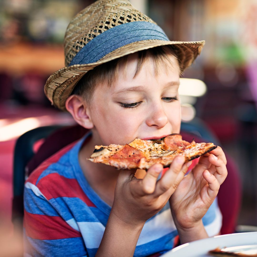 A kid eating pizza