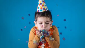 kid blowing glitter